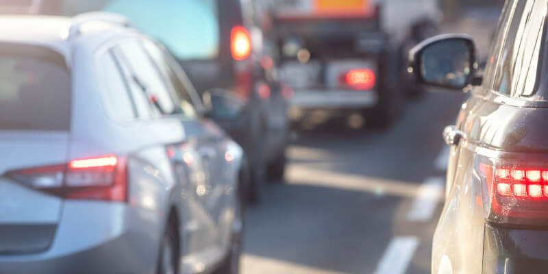 Blurry row of cars in a traffic jam on the road