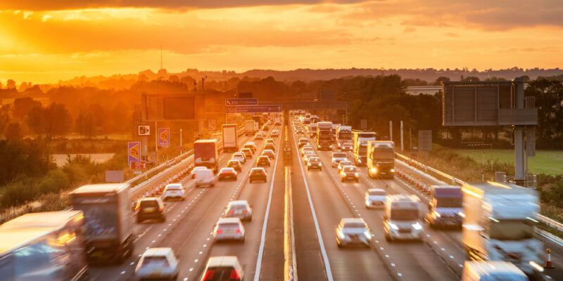 Heavy traffic driving in both directions on a UK motorway