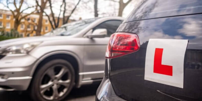 L-plate stuck to rear of a car
