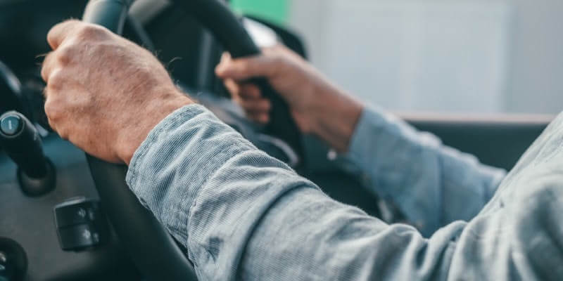 Hands on steering wheel in the 10-2 position