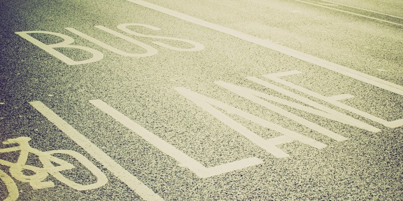 Faded picture of a bus and cycle lane