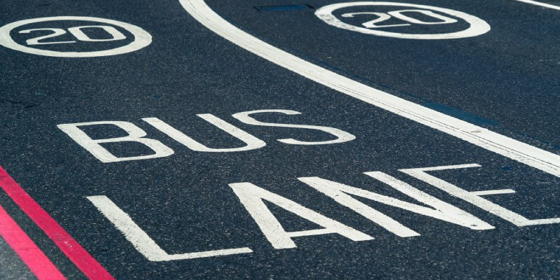 Bus lane and 20 limit speed printed on tarmac